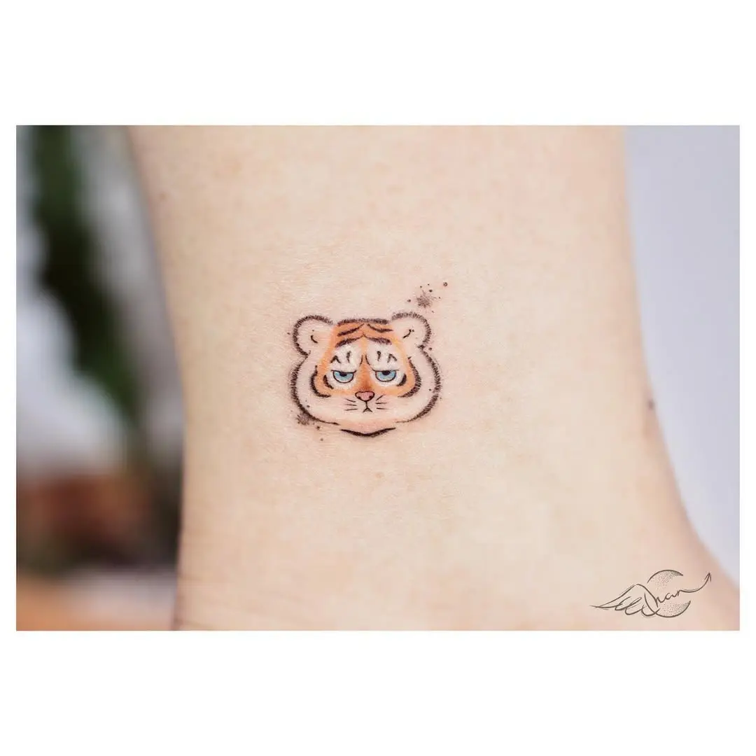 Cute and minimalistic tiger face tattoo design