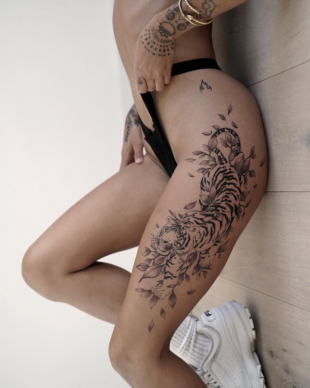 Striking Tiger Tattoo with Floral Elements