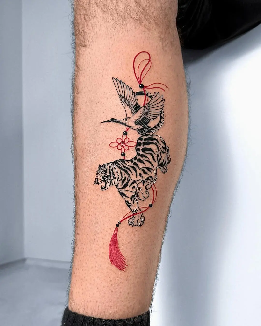 Dynamic tiger and bird tattoo design