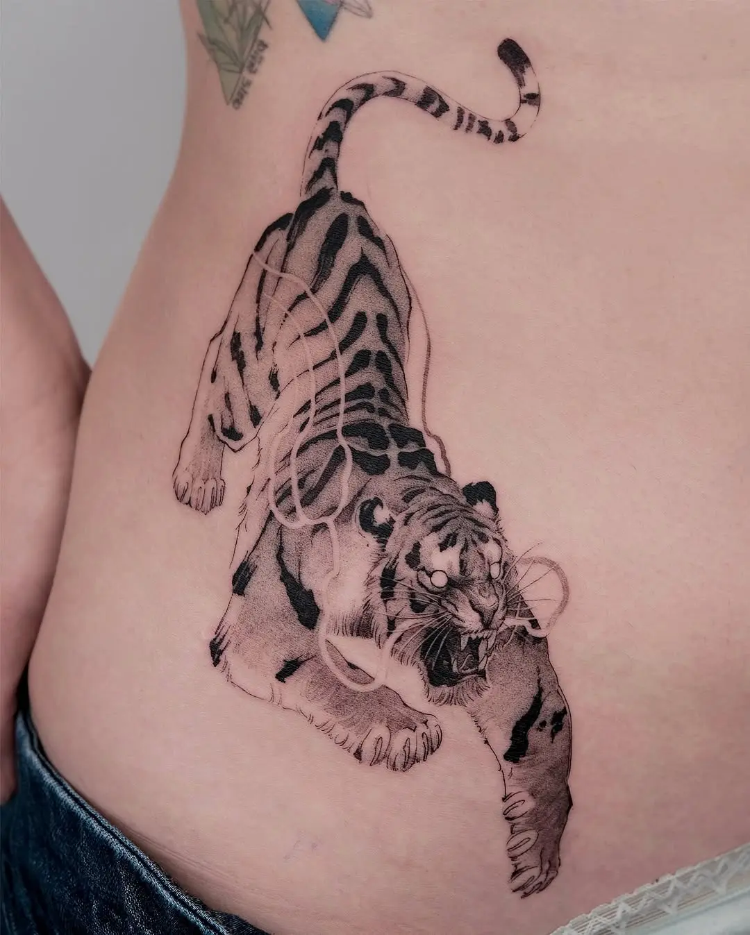 Fierce tiger tattoo exuding raw energy