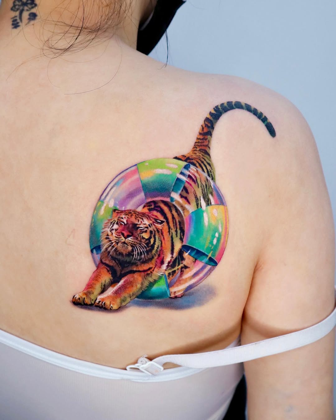 A colorful tiger climbing through a bubble