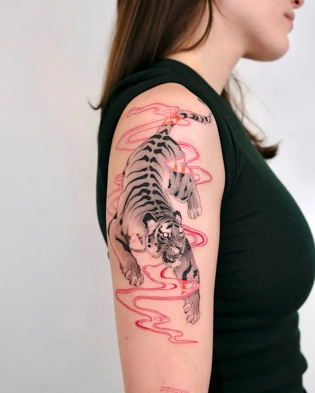 Dynamic tiger tattoo with vibrant swirl accents