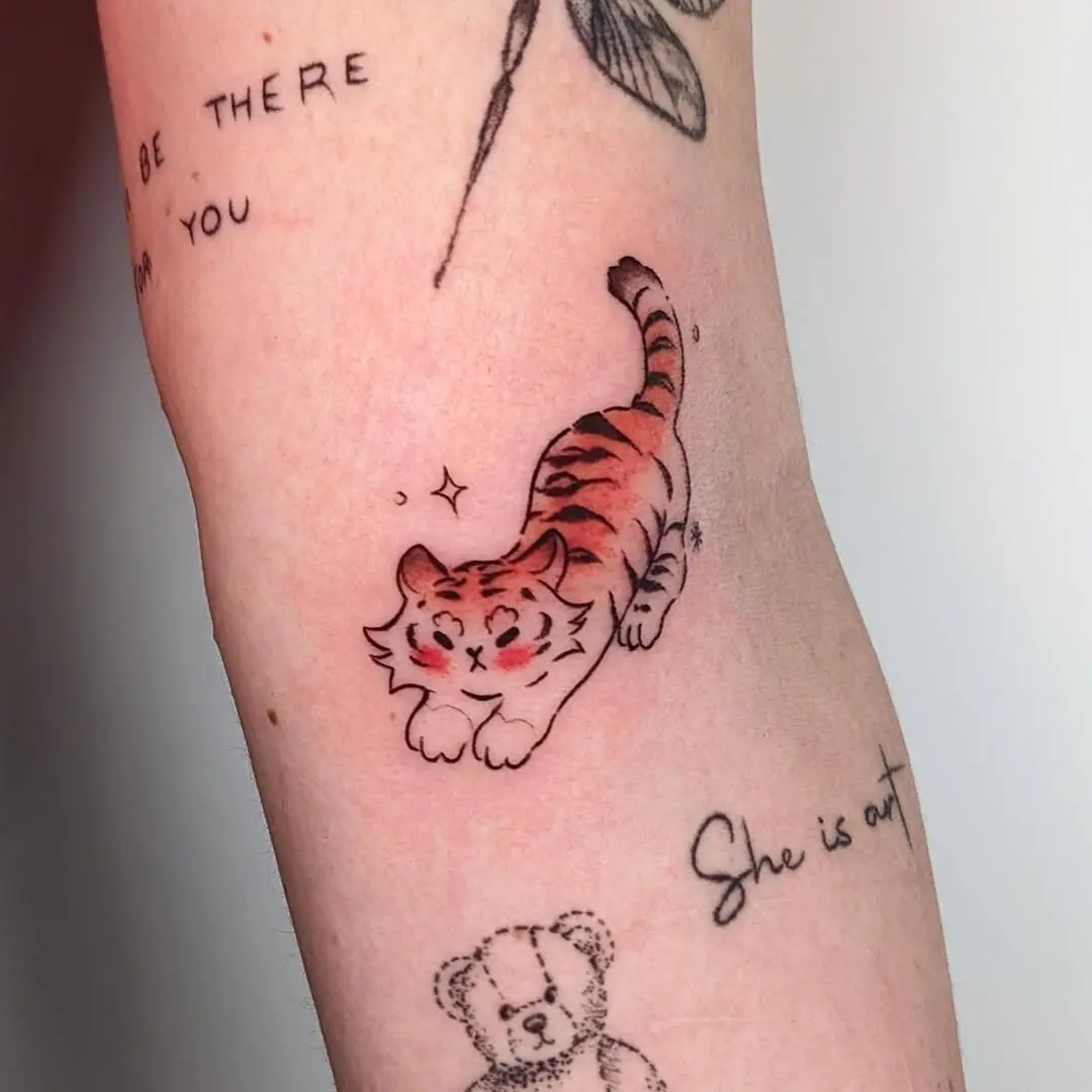 Charming playful tiger tattoo showcasing vibrant colors