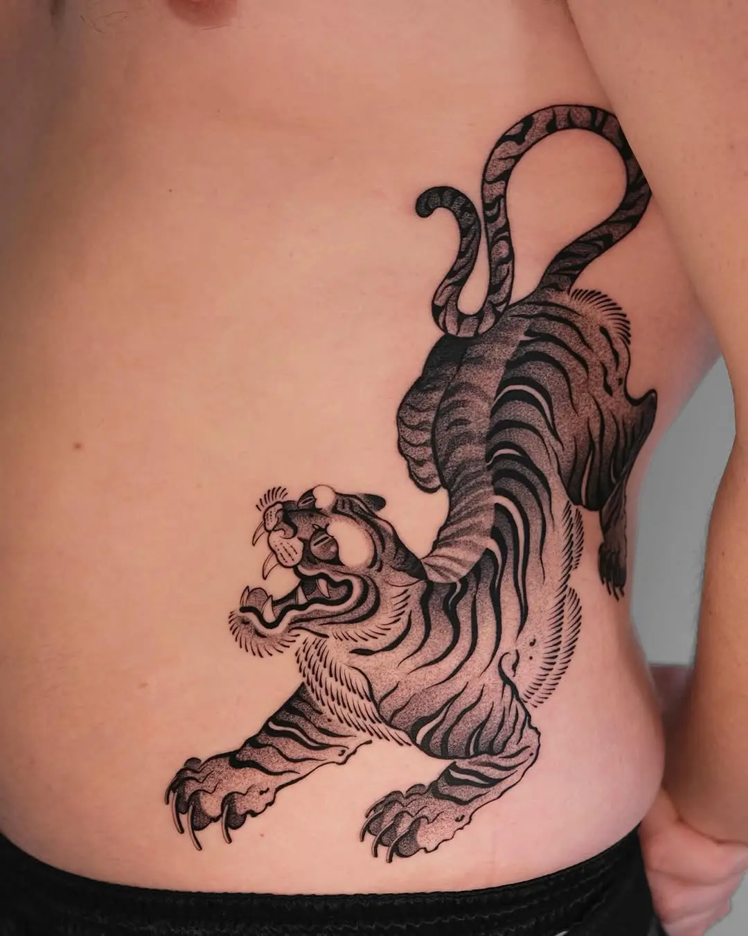 Bold and fierce tiger side tattoo design