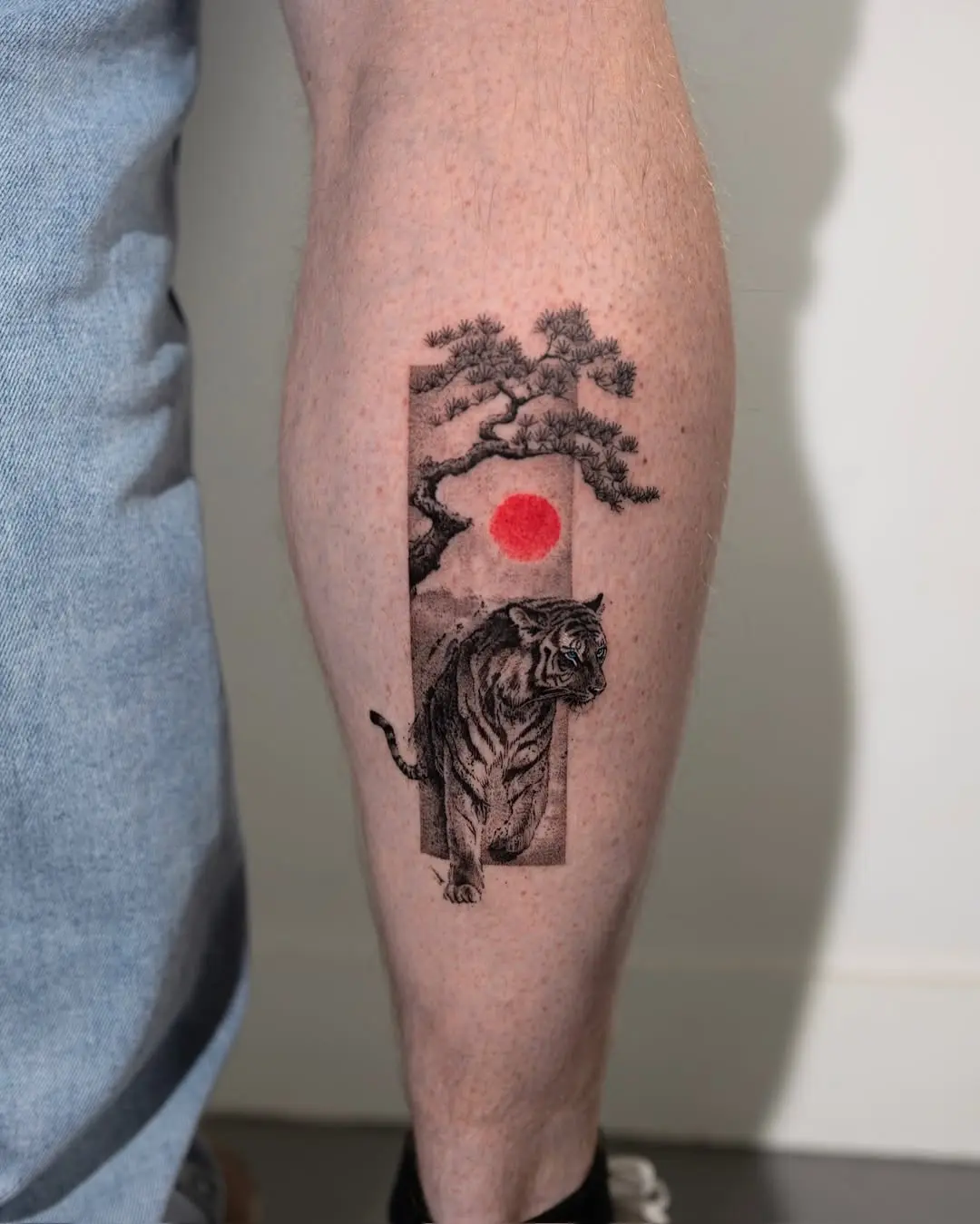Striking tiger tattoo with sun and trees