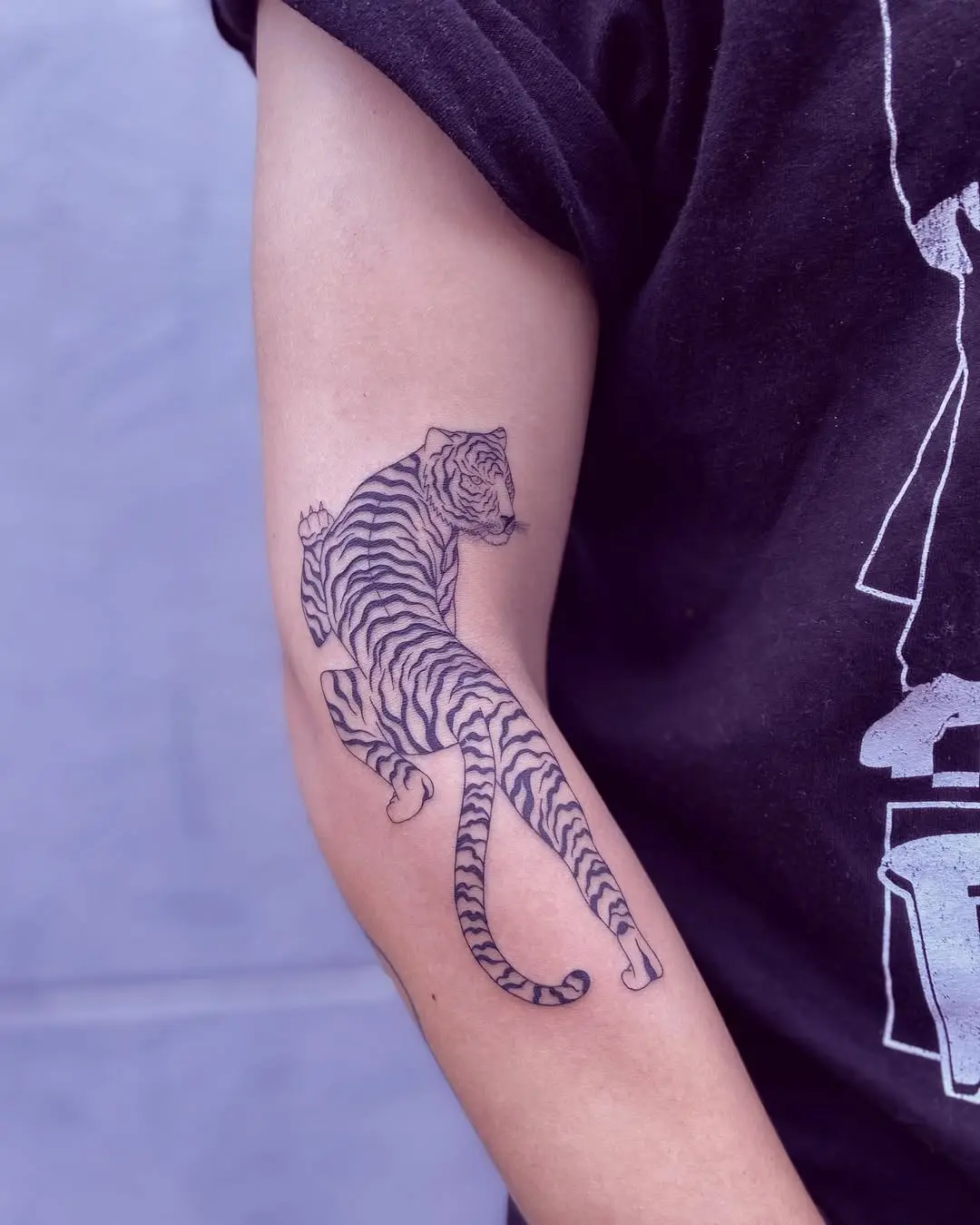 Dynamic tiger tattoo showcasing strength and elegance