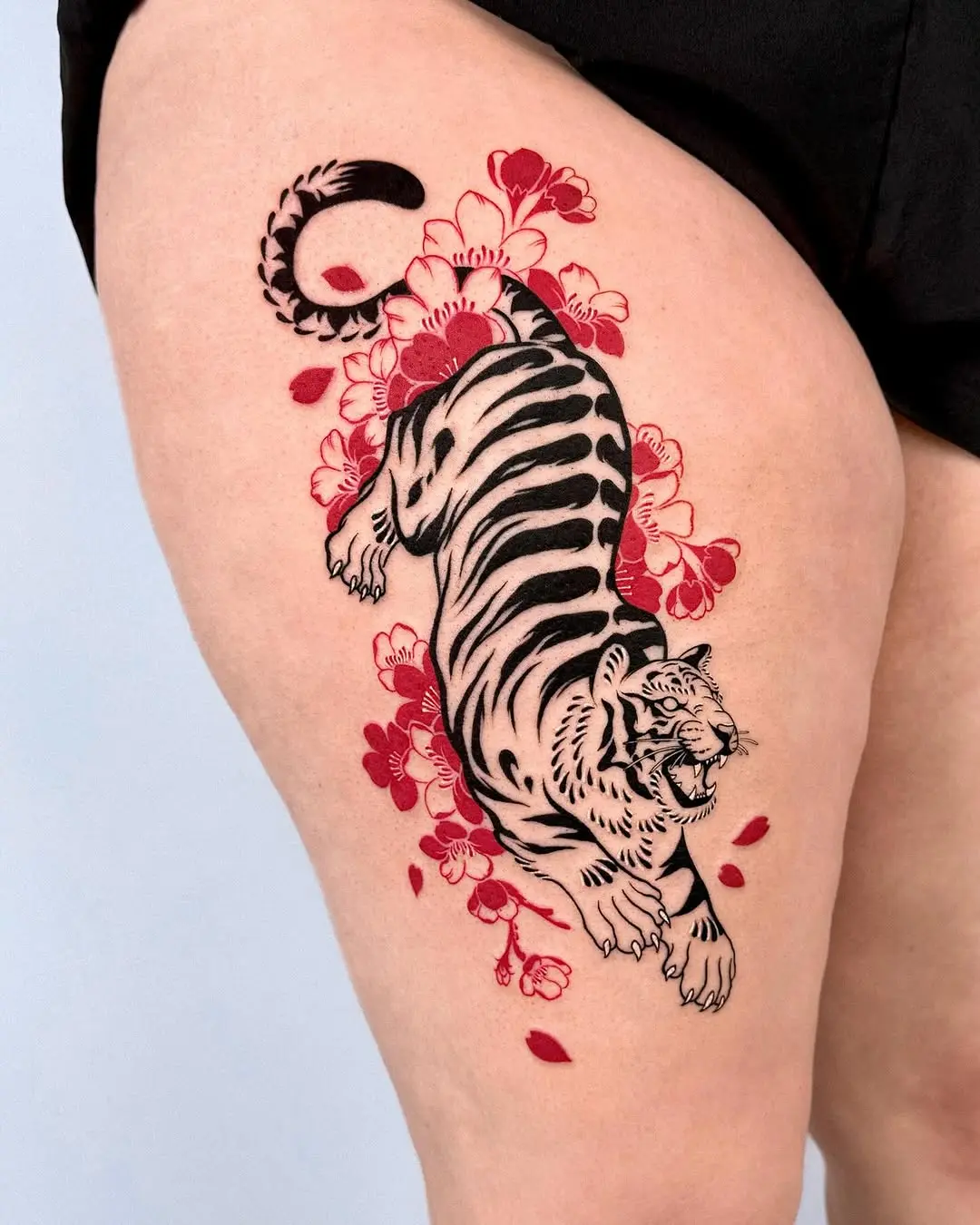 Vibrant tiger tattoo with floral accents