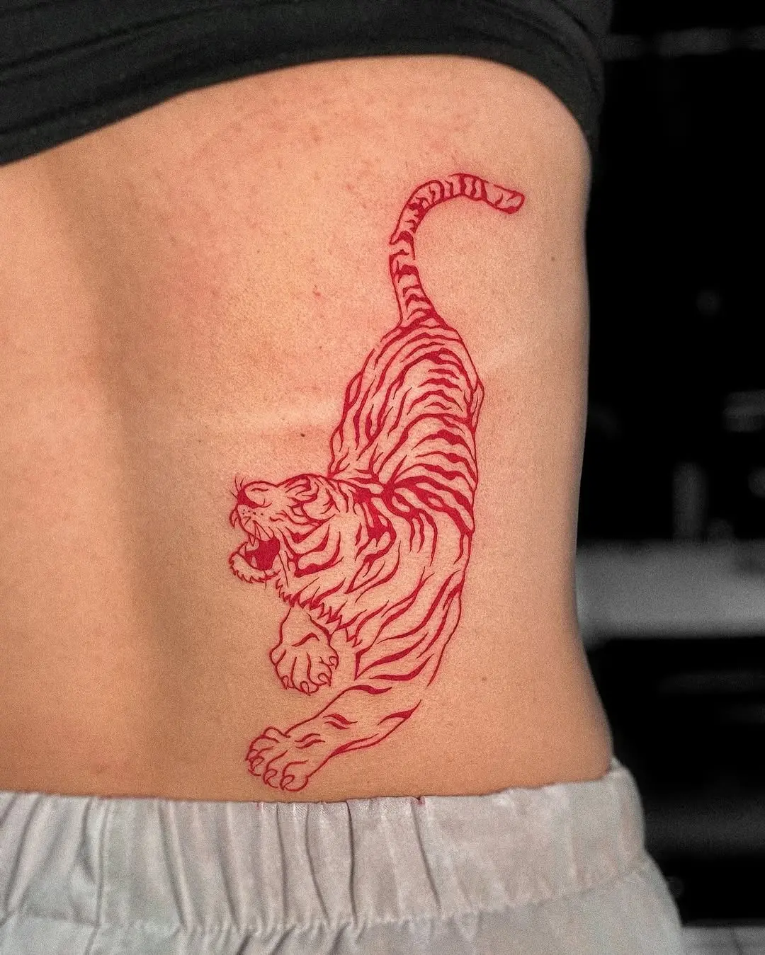 Dynamic red ink tiger tattoo design