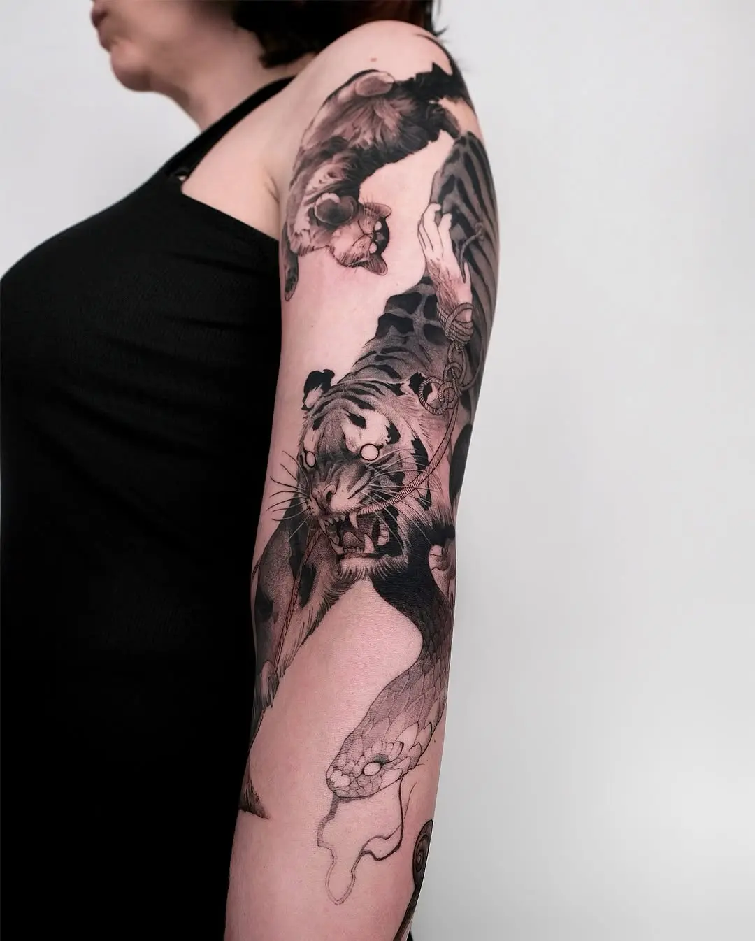 Striking black ink tiger tattoo on arm
