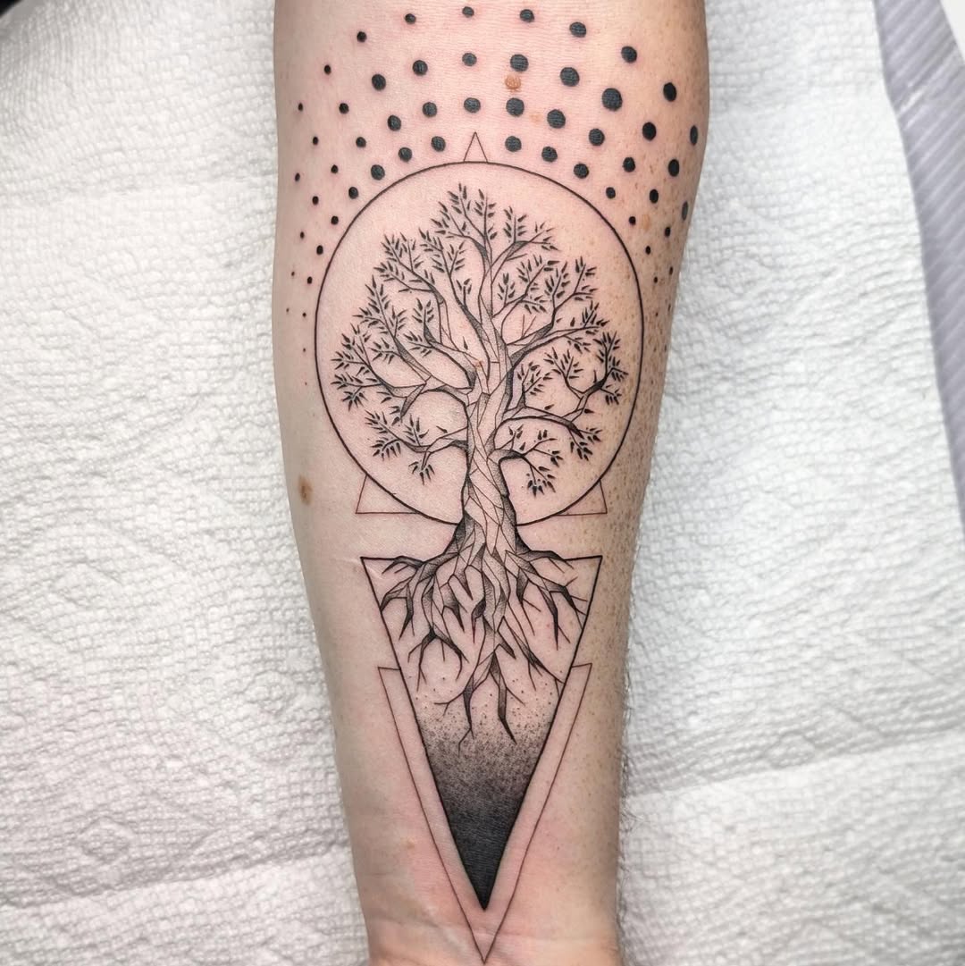 Intricate tree of life tattoo in black ink