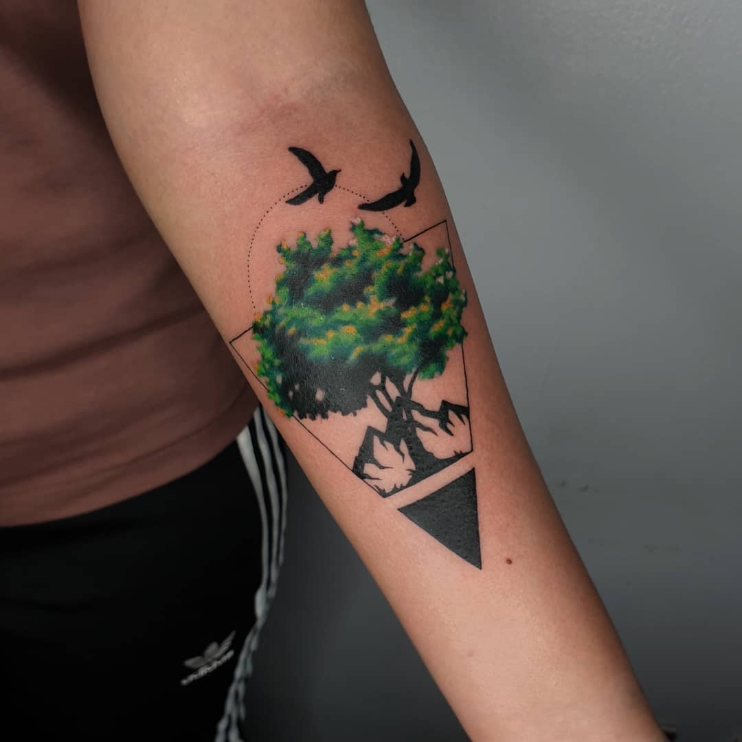 Vibrant tree of life tattoo with birds