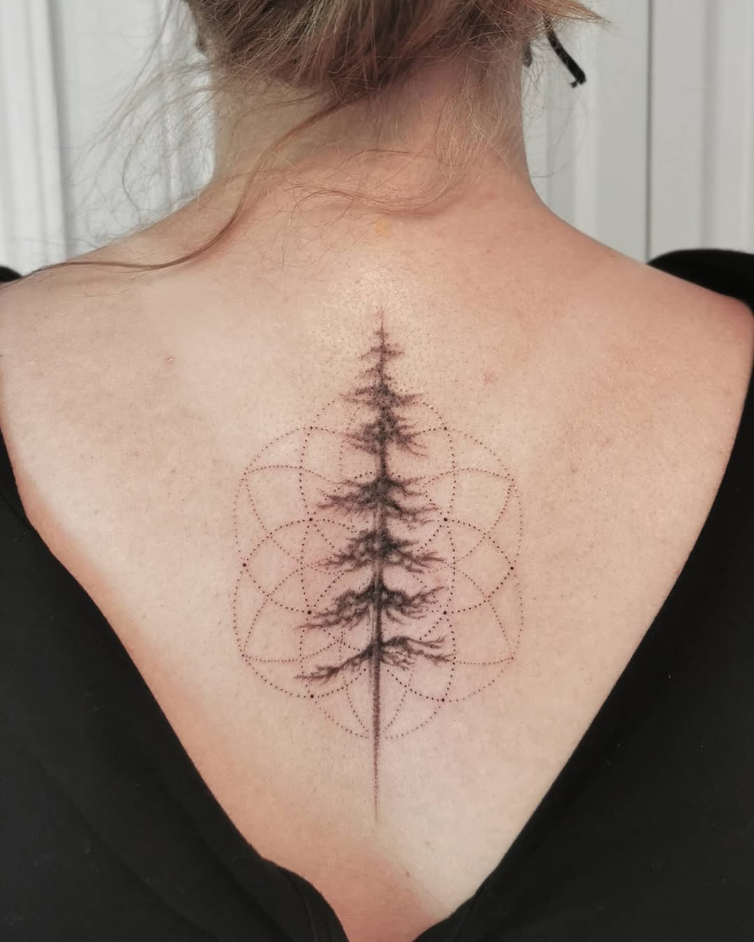 Elegant geometric tree of life tattoo design