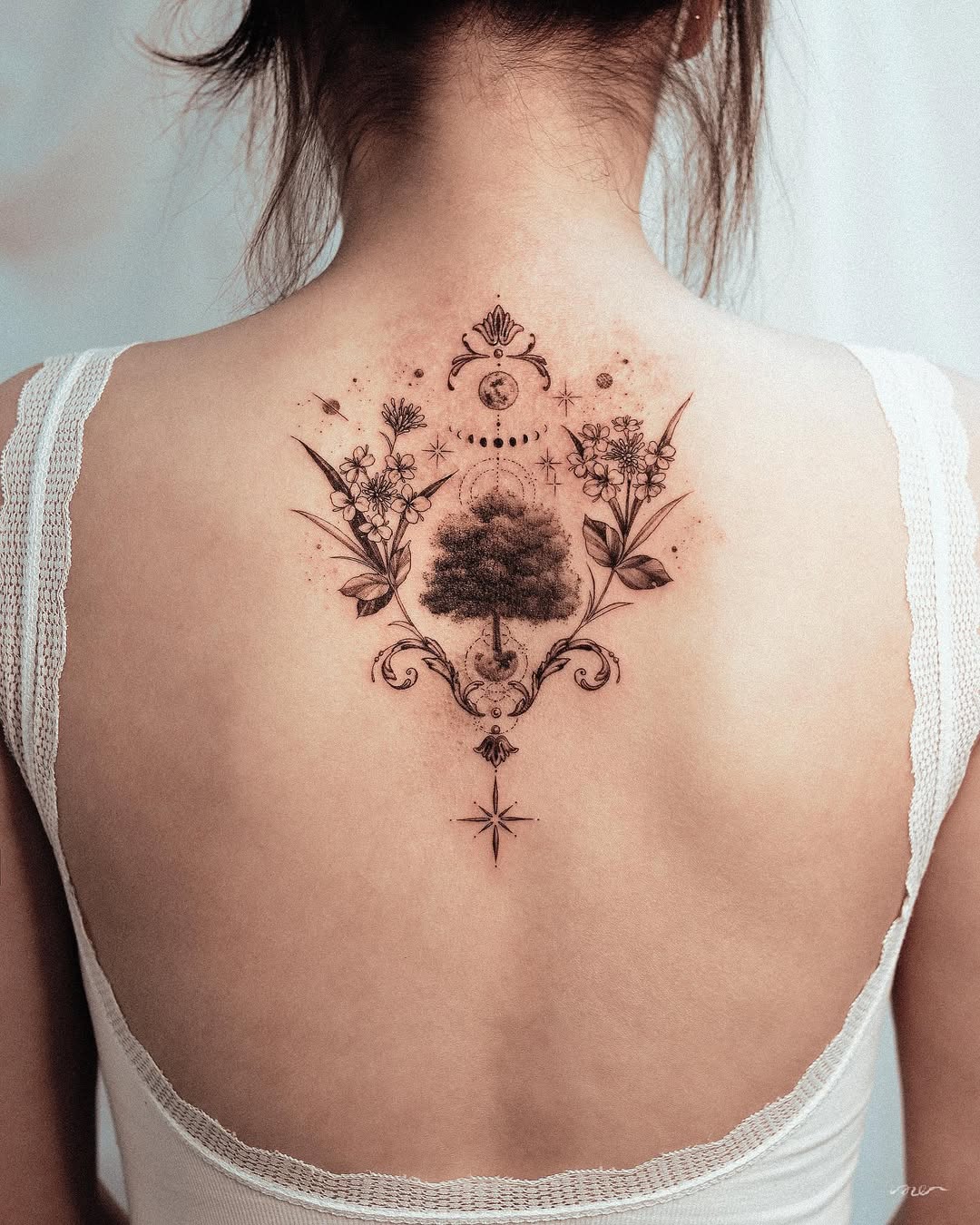 Nature-inspired tree of life tattoo on back