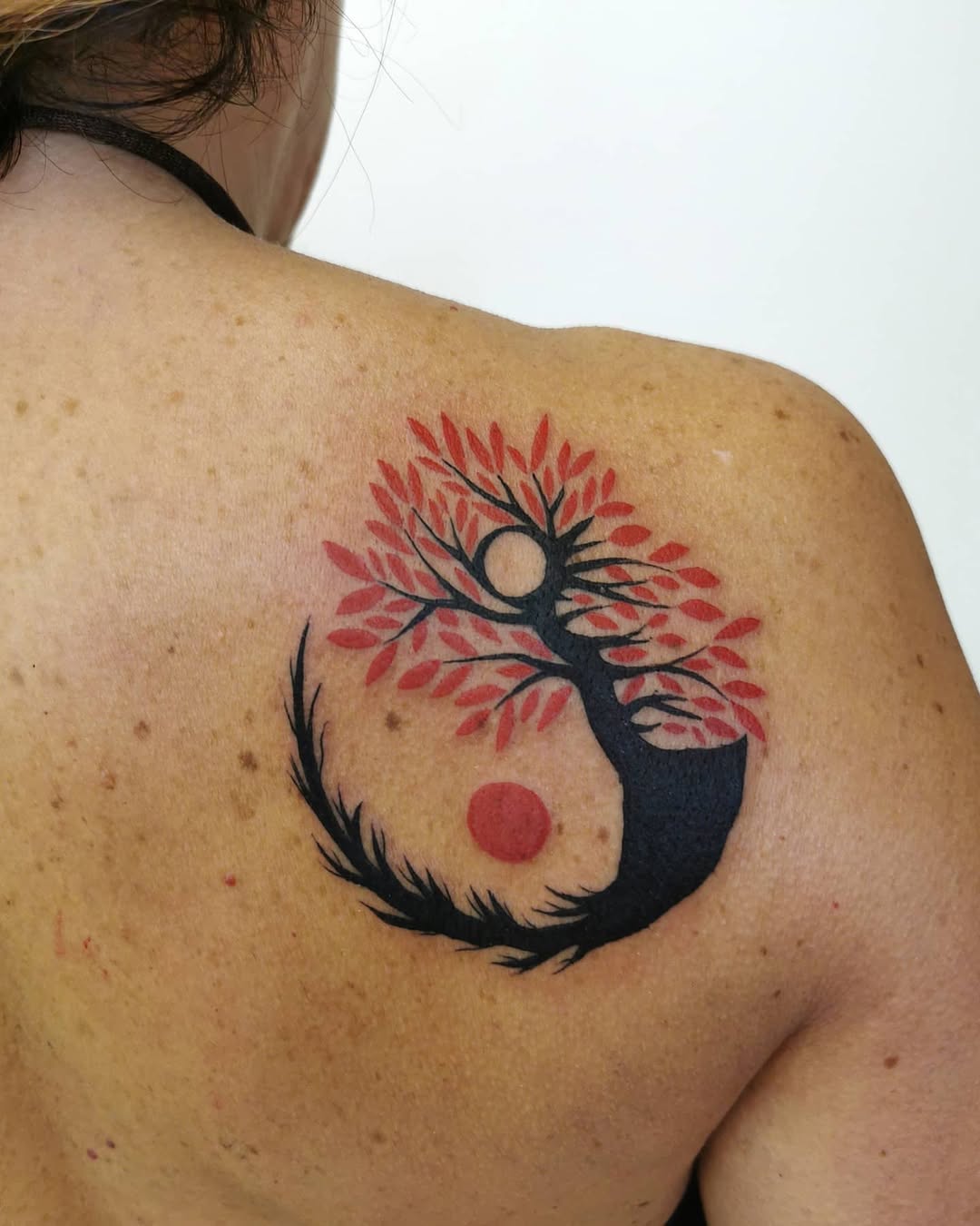 Vibrant tree of life tattoo with sun and moon