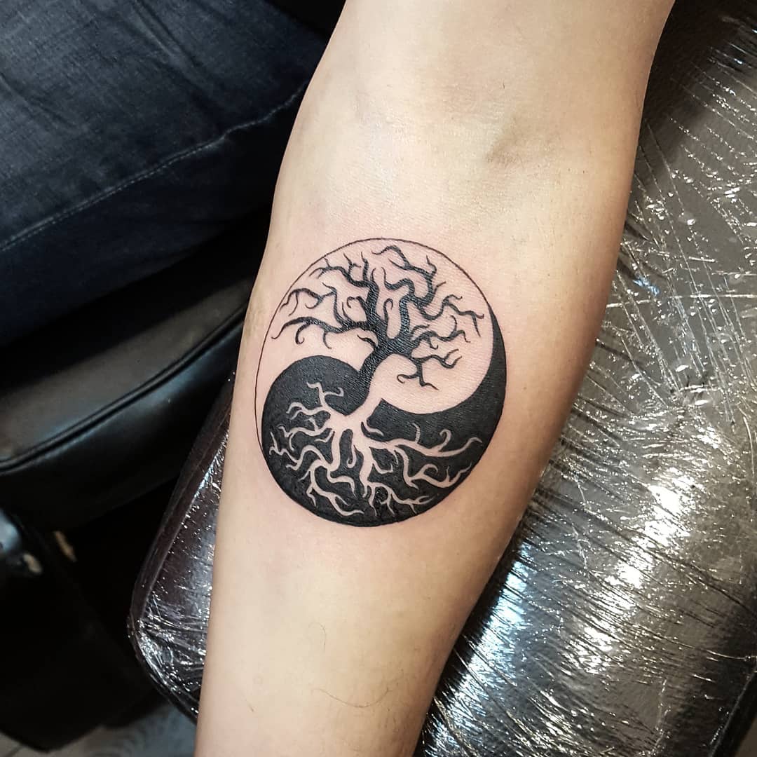 Intricate tree within yin yang tattoo design