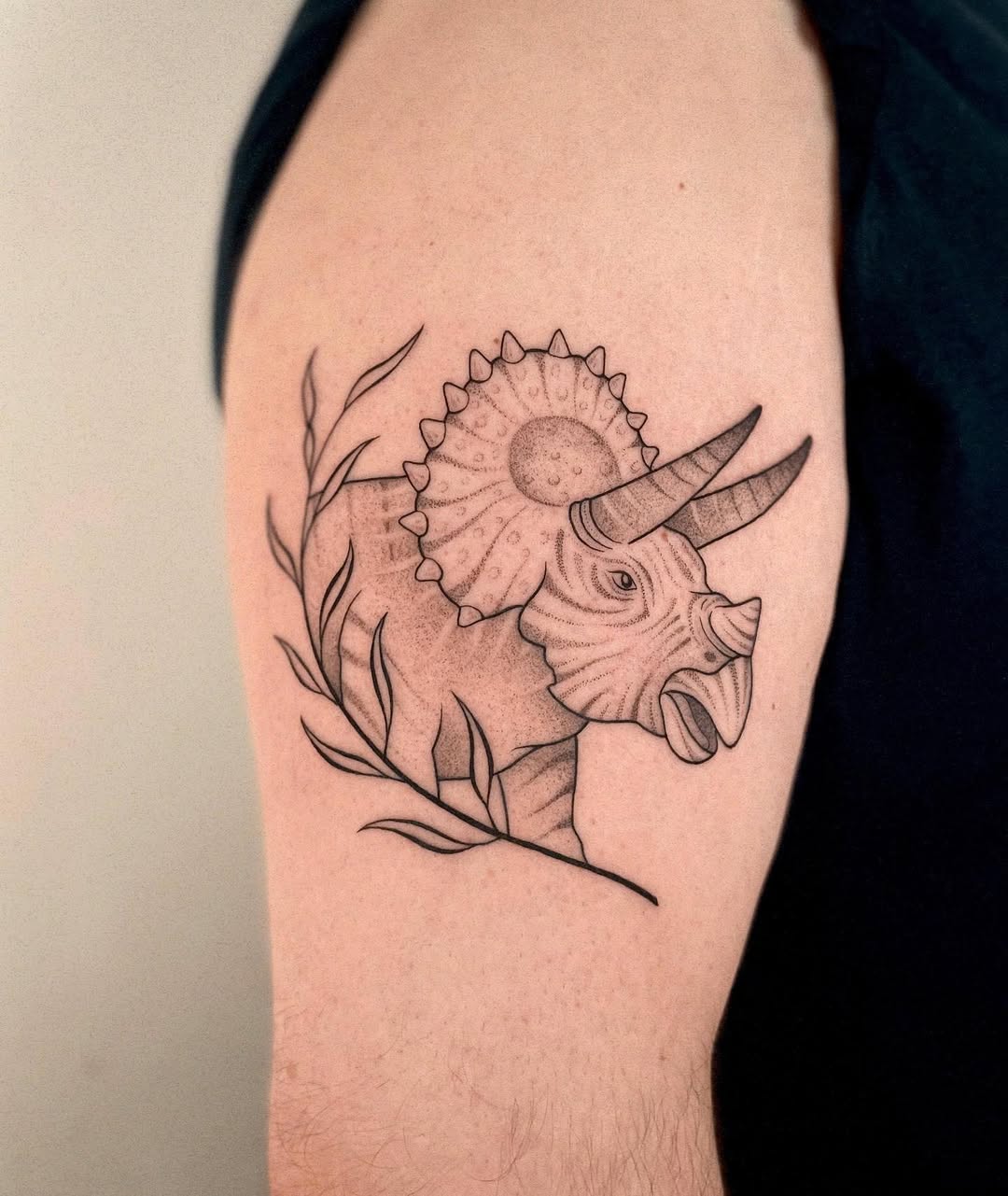 Elegant triceratops tattoo with intricate details