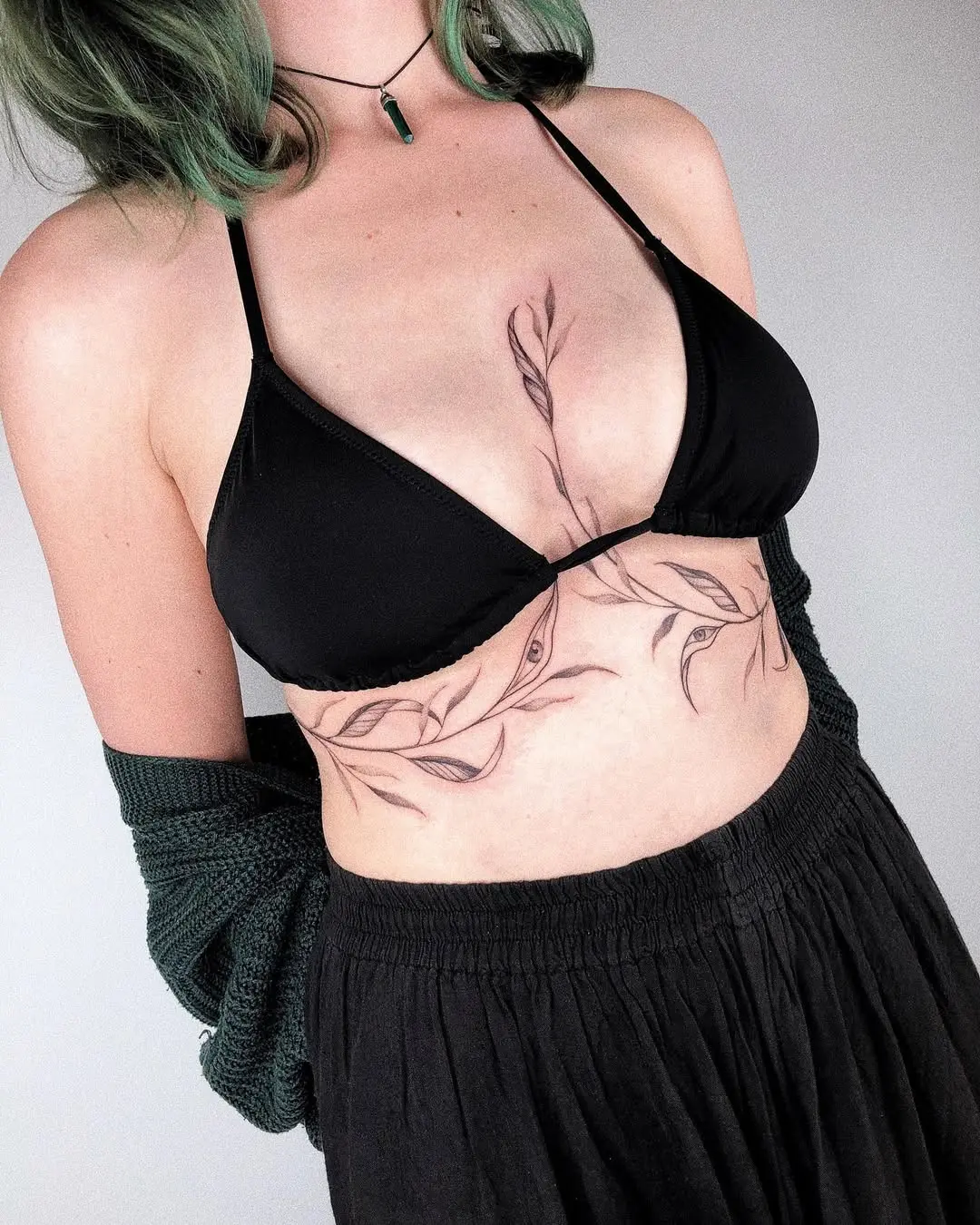Stylish underboob tattoo featuring floral motifs