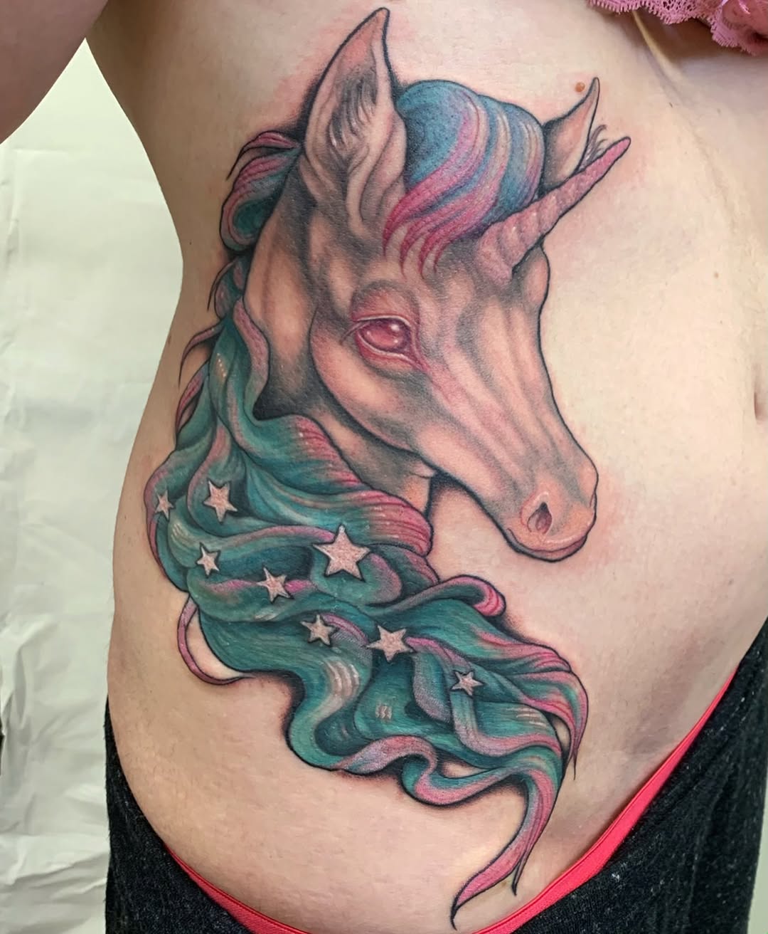 Whimsical unicorn tattoo with vibrant colors