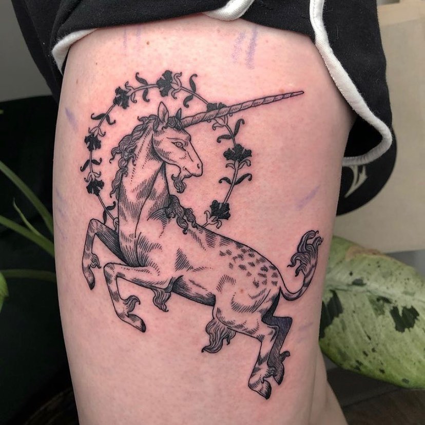 Elegant Unicorn Tattoo with Floral Accents