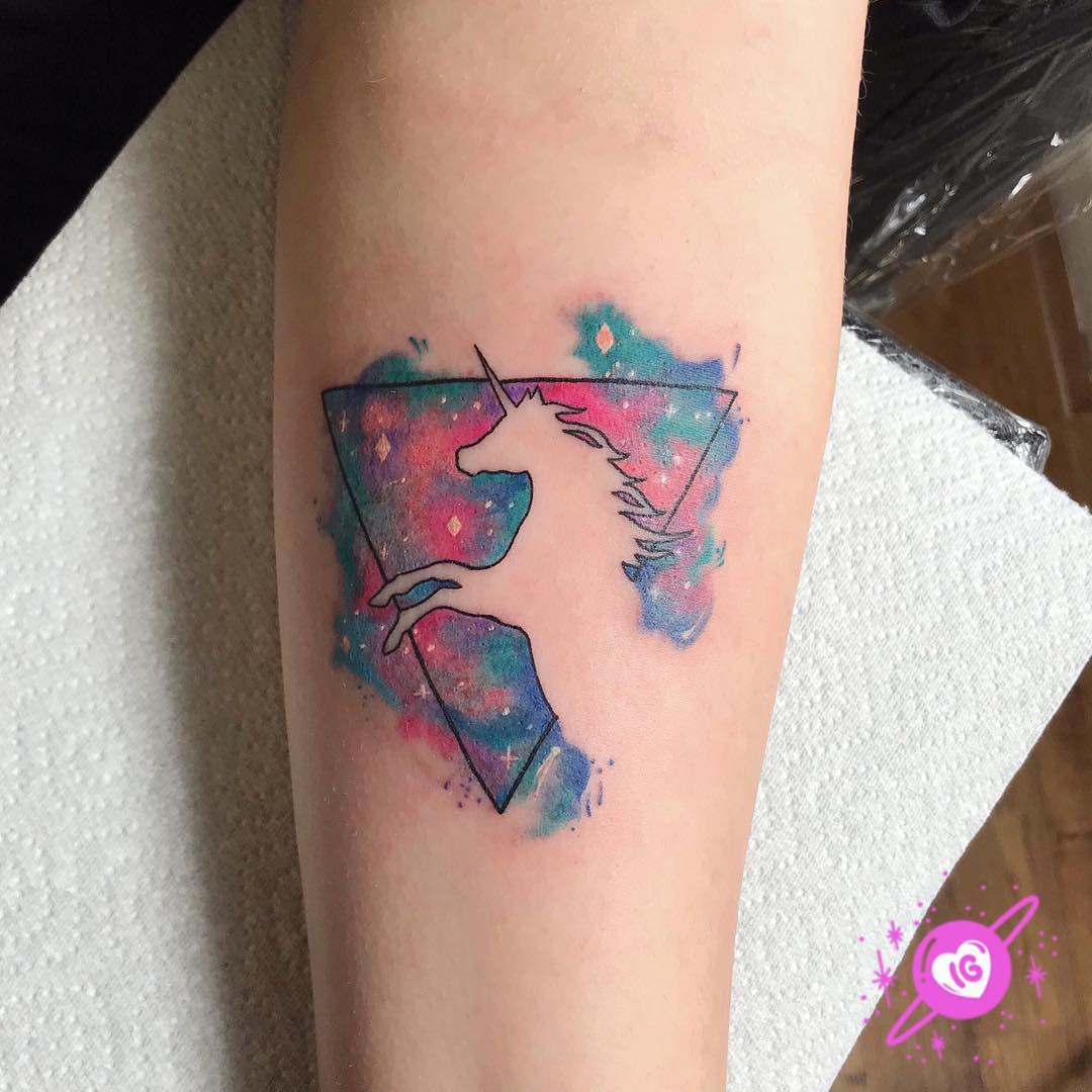 Whimsical unicorn tattoo with galaxy aura