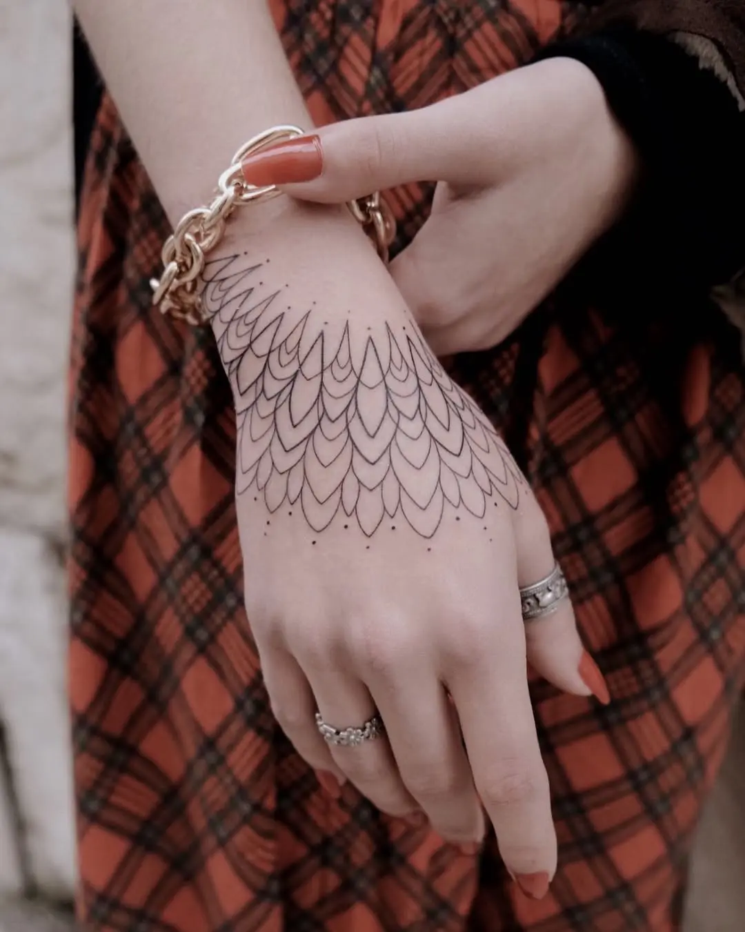 Intricate pattern adorning a stylish hand tattoo