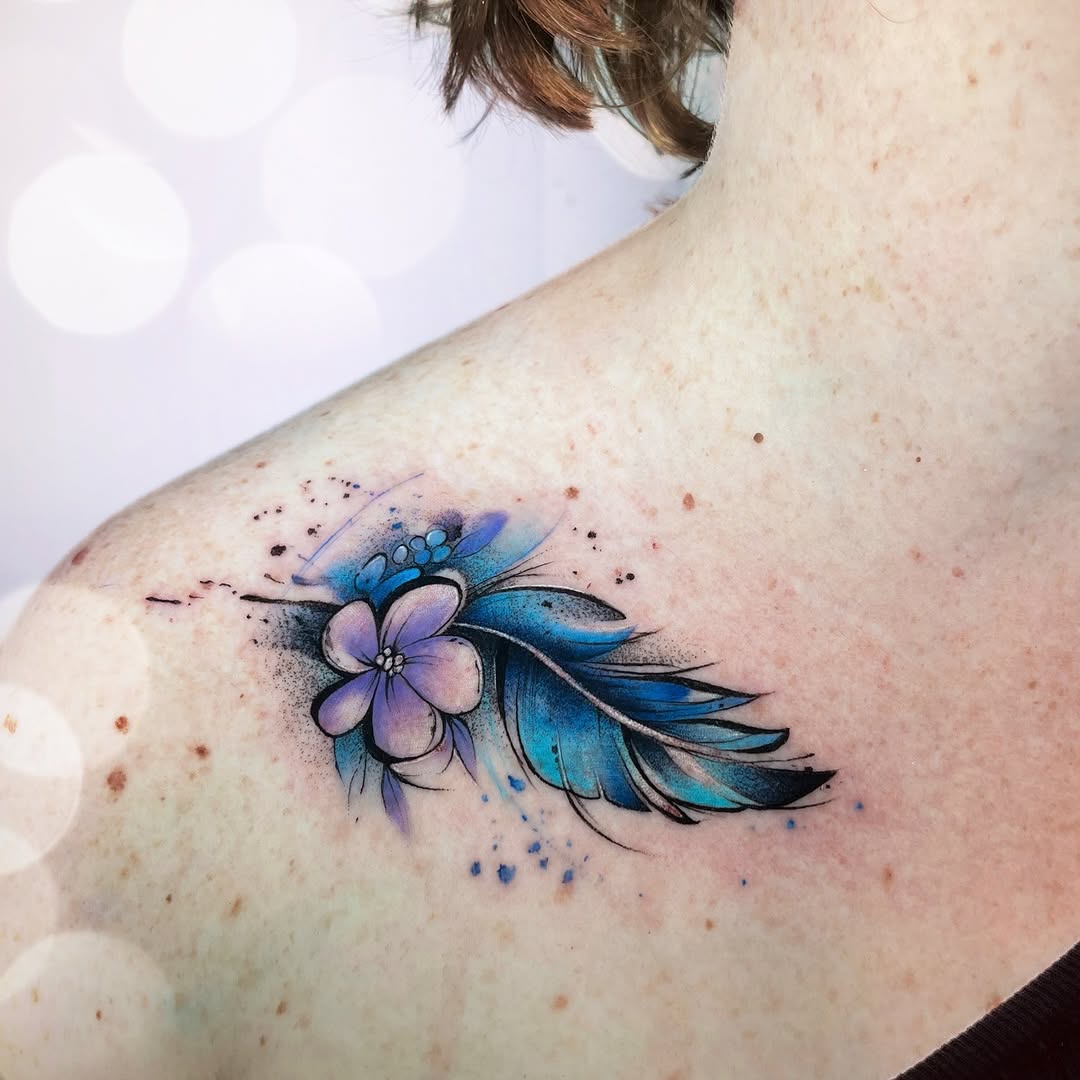 Stunning feather tattoo with floral elements