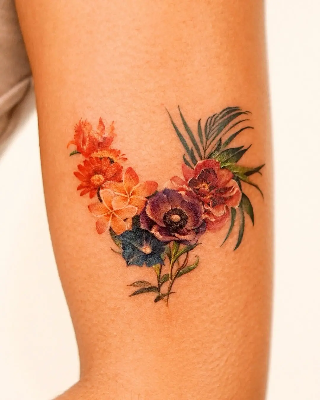 Colorful floral watercolor tattoo on arm