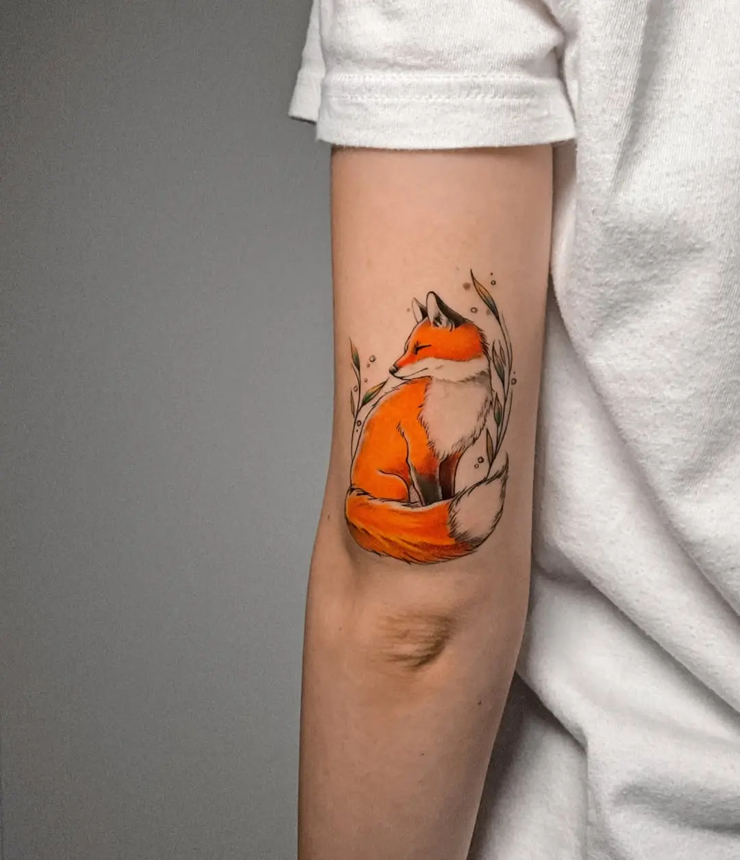Enchanting watercolor fox tattoo on the arm