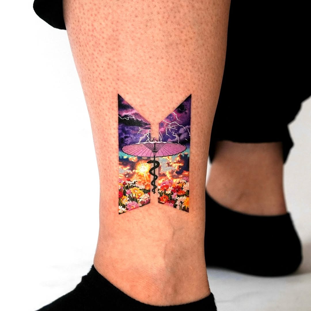 Bold butterfly landscape tattoo on calf