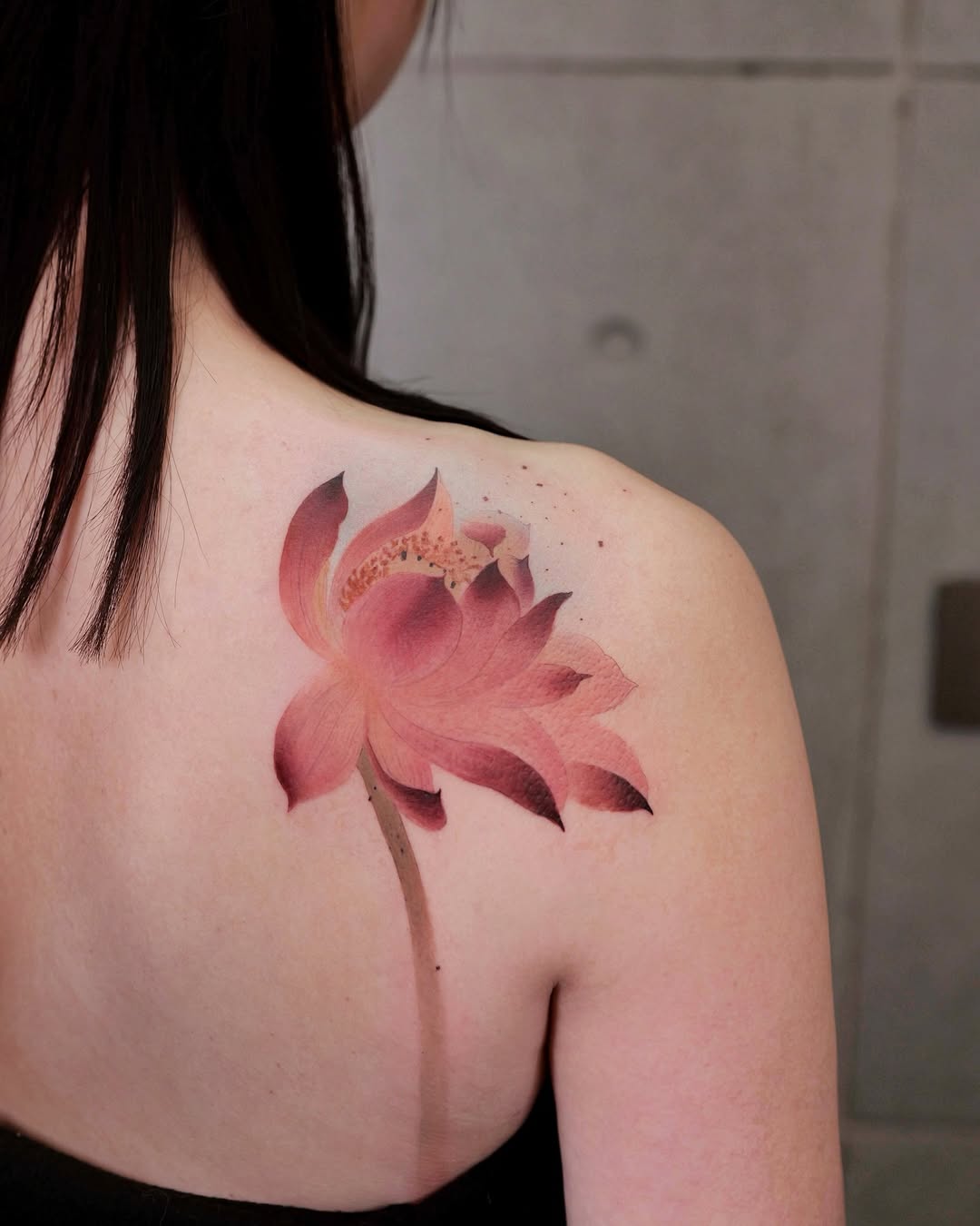 Elegant lotus flower tattoo on shoulder