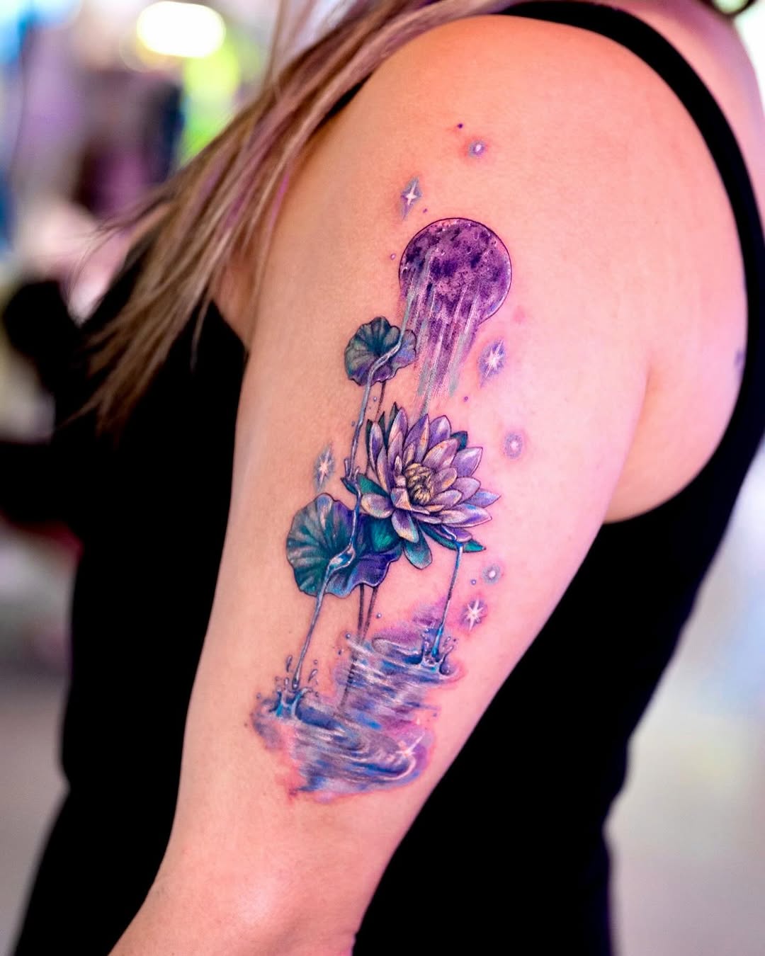 Stunning lotus tattoo with a celestial vibe