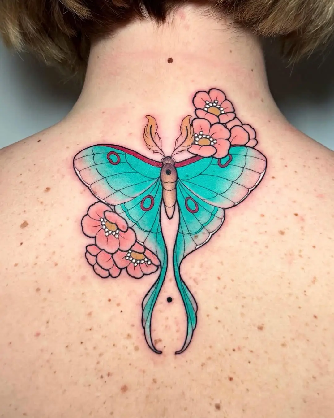 Colorful Moth Tattoo Blending with Flowers