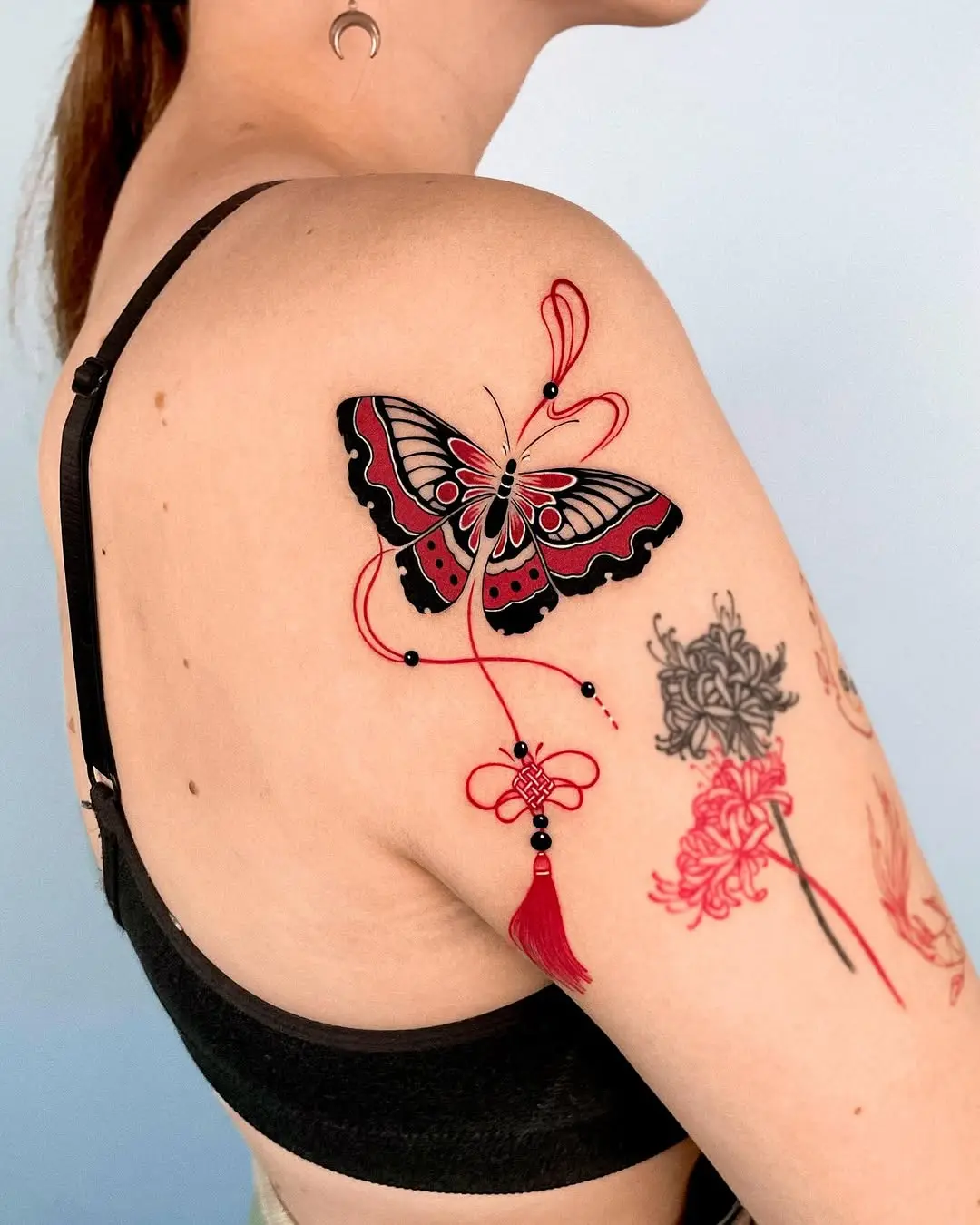 Elegant red and black butterfly tattoo design