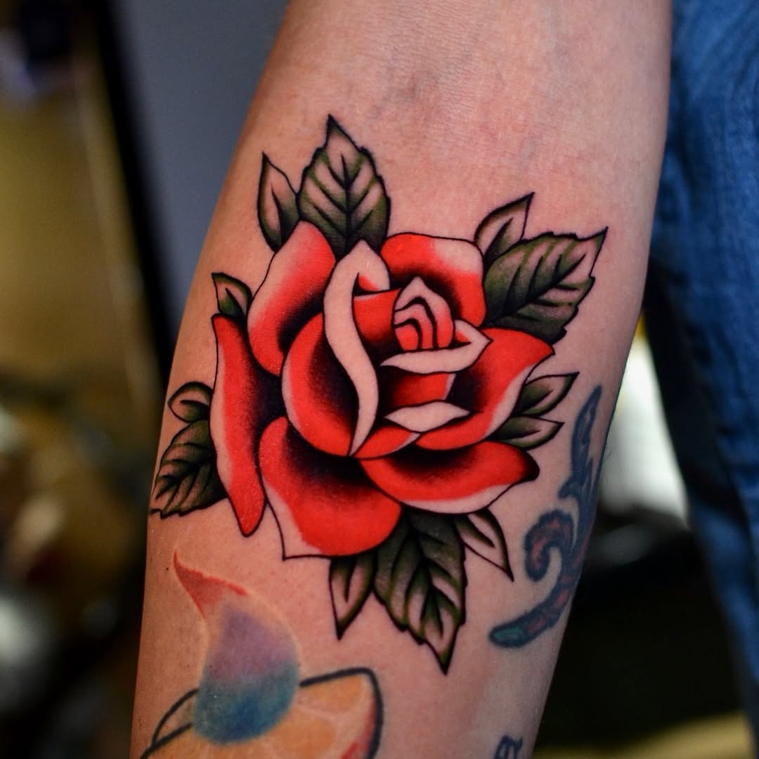 Bold and vibrant rose tattoo on the arm