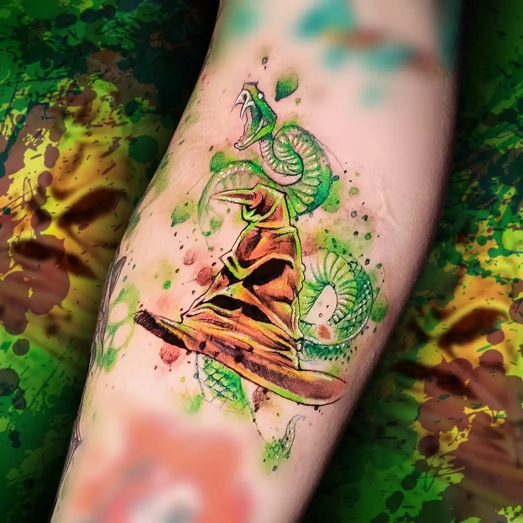 Bold watercolor snake and hat tattoo design
