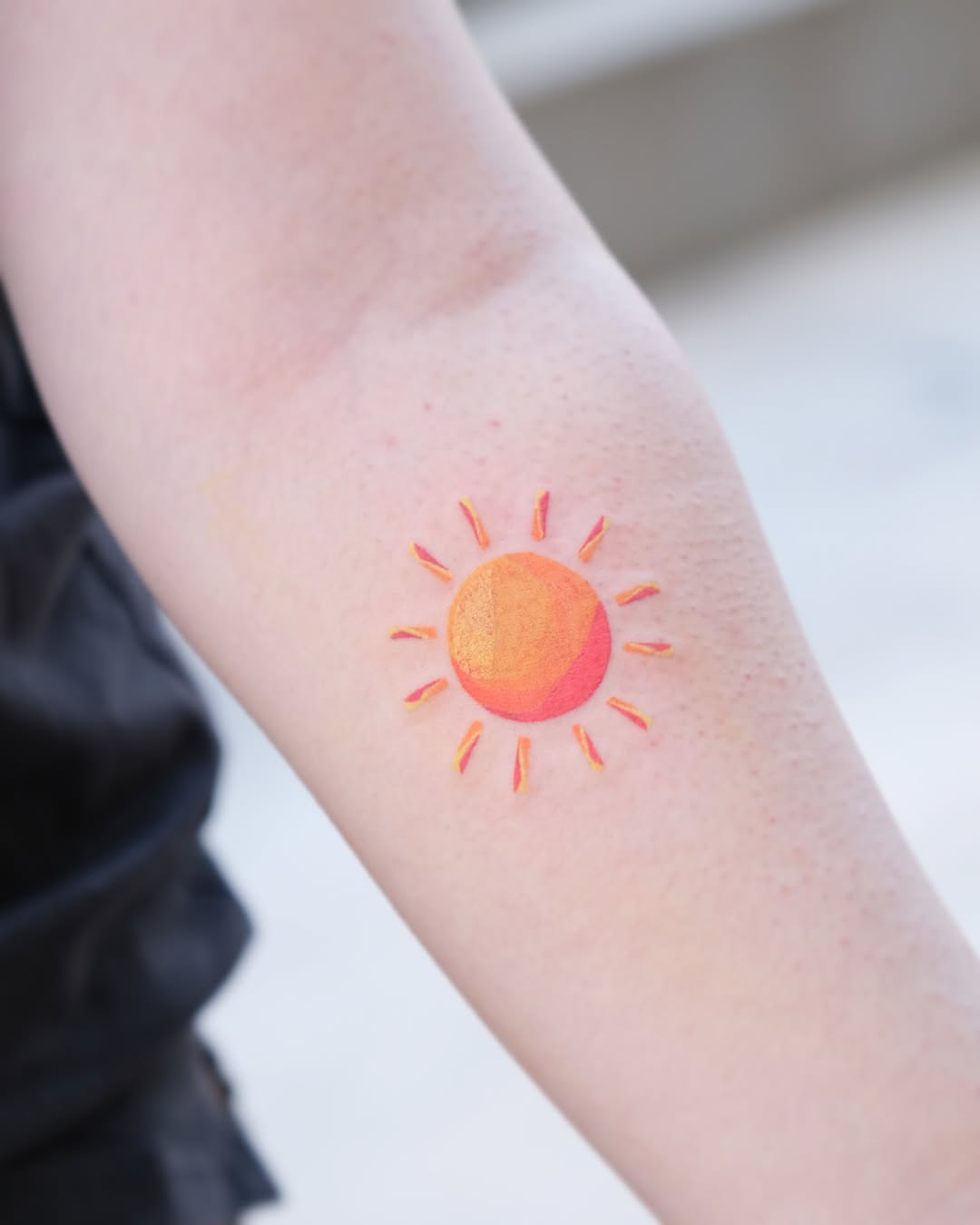 Bright and cheerful sun tattoo design