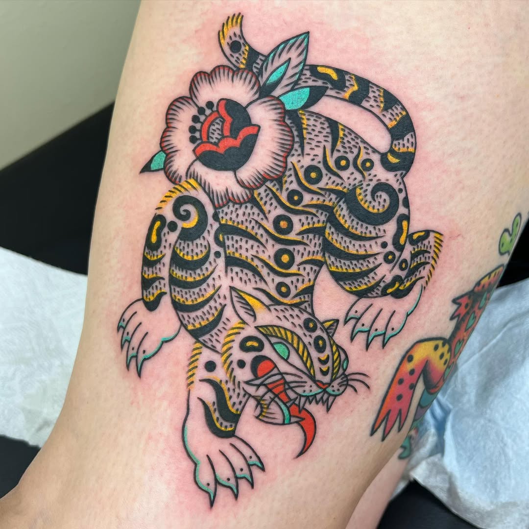 Vibrant tiger tattoo with floral accents