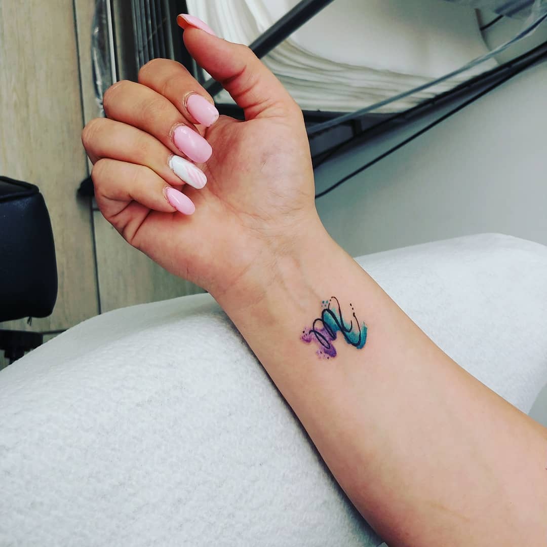 Vibrant Virgo Tattoo on Delicate Wrist