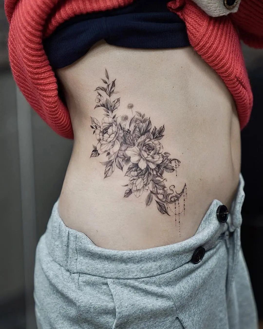 Elegant floral waist tattoo design for women