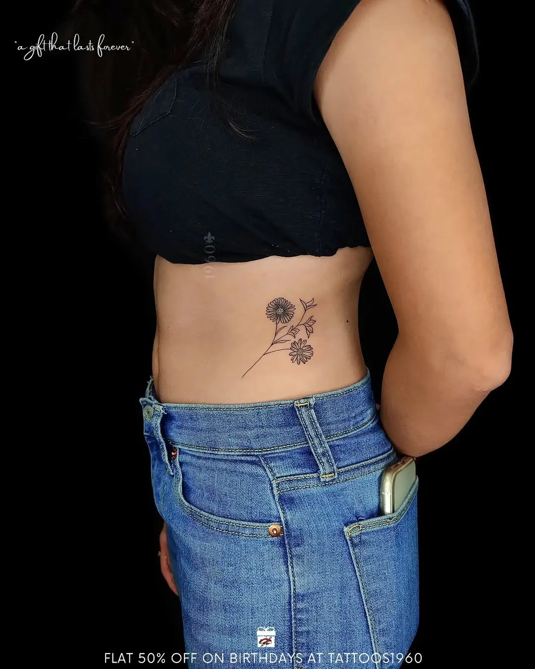 Delicate floral waist tattoo design in black ink