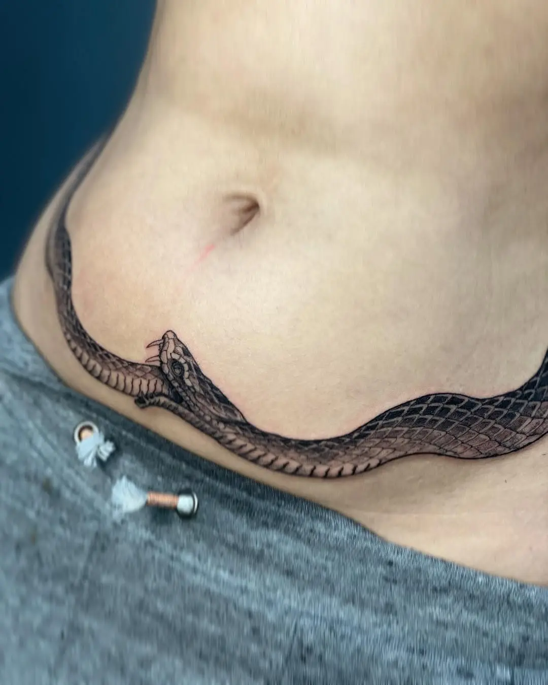Sleek snake design wraps gracefully around waist