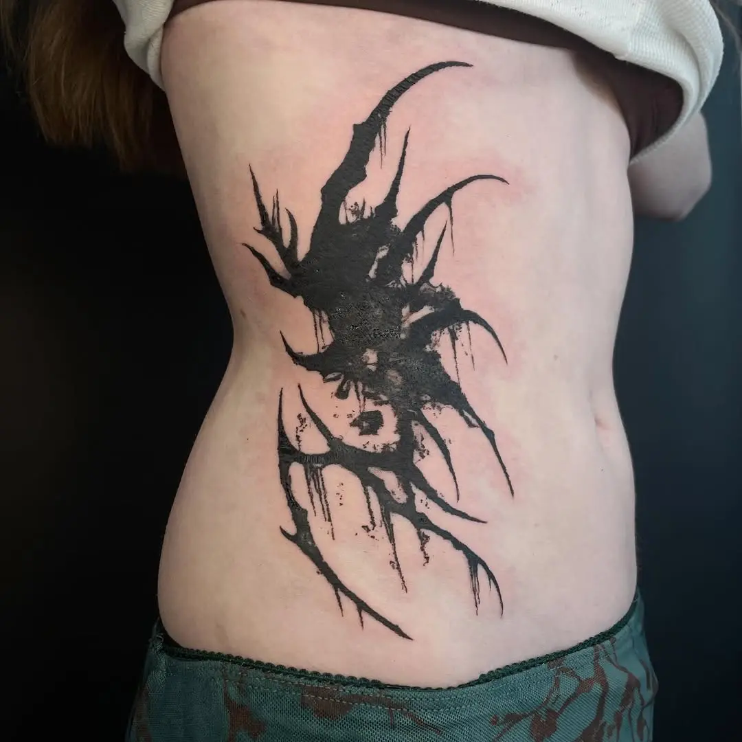 Abstract black ink waist tattoo design