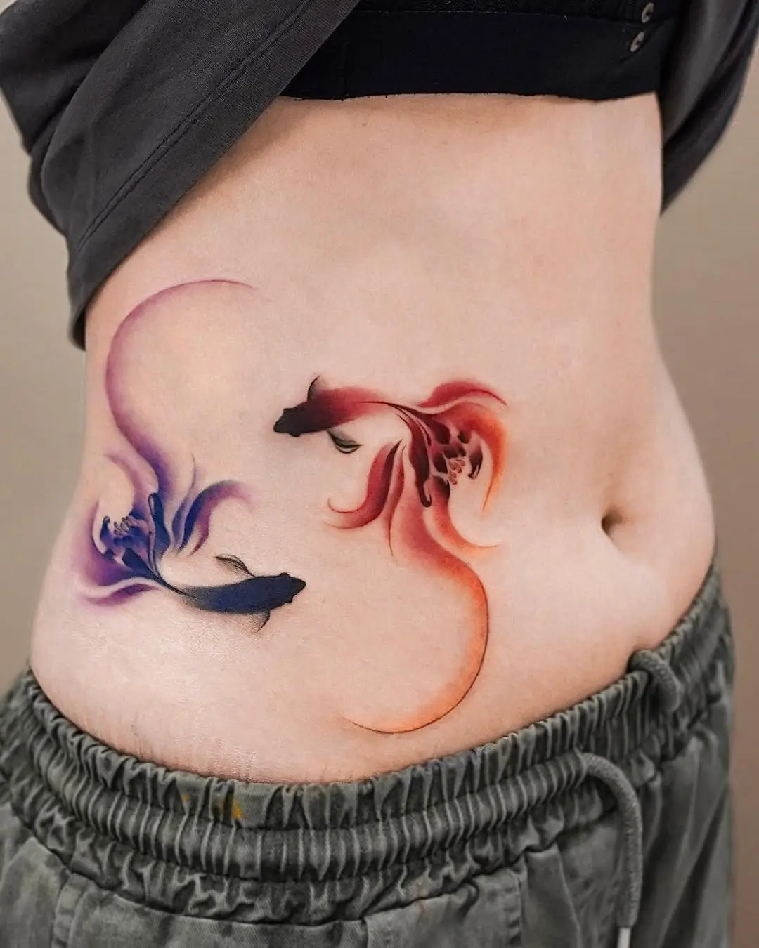 Stunning fish tattoos on the waist area
