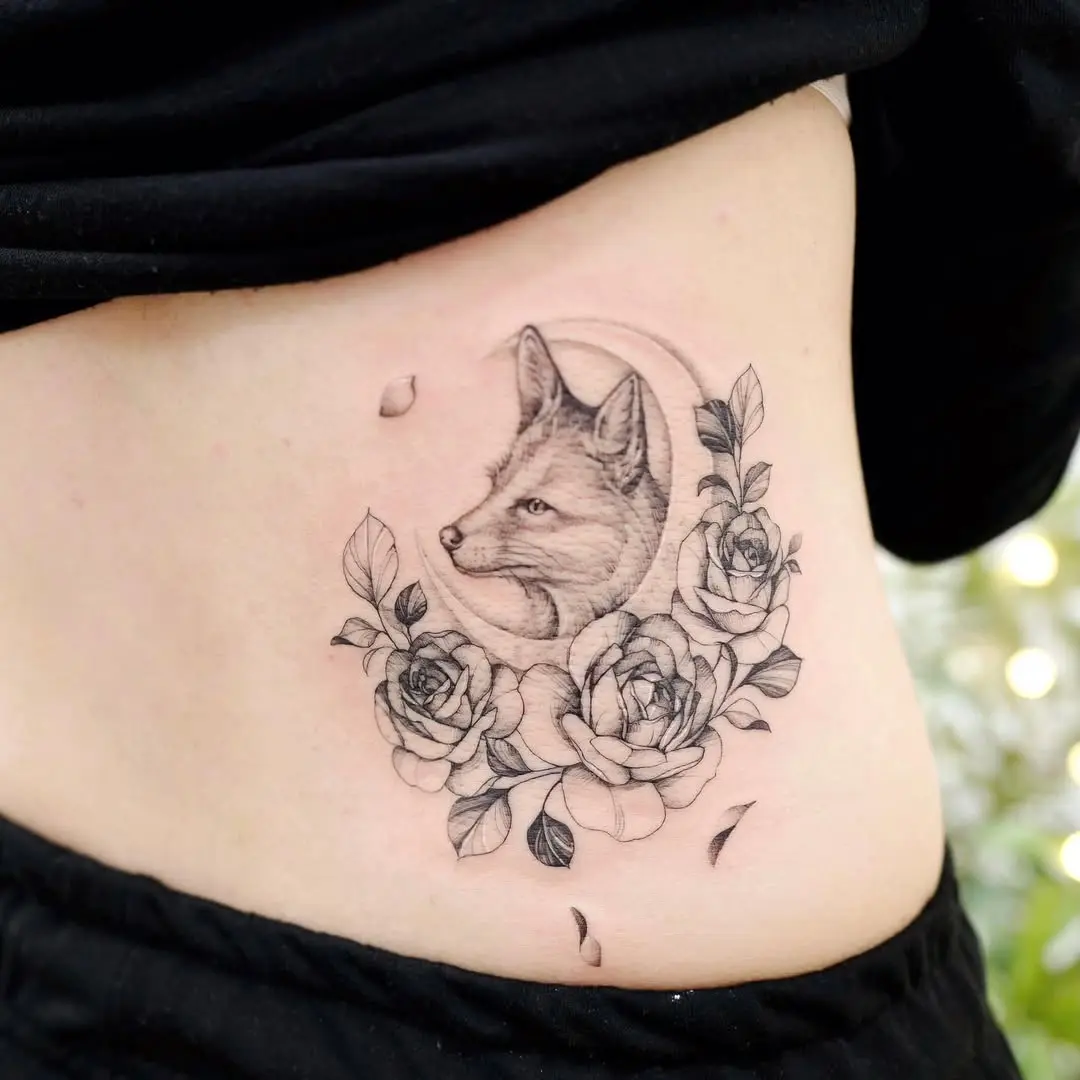 Elegant fox surrounded by blooming roses tattoo