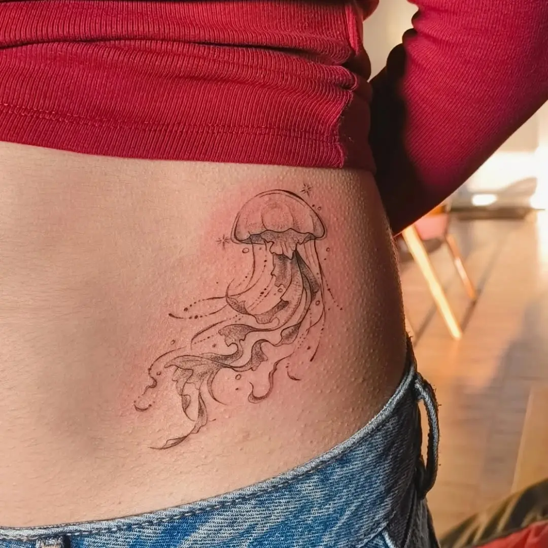 Elegant jellyfish tattoo gracing the waist area