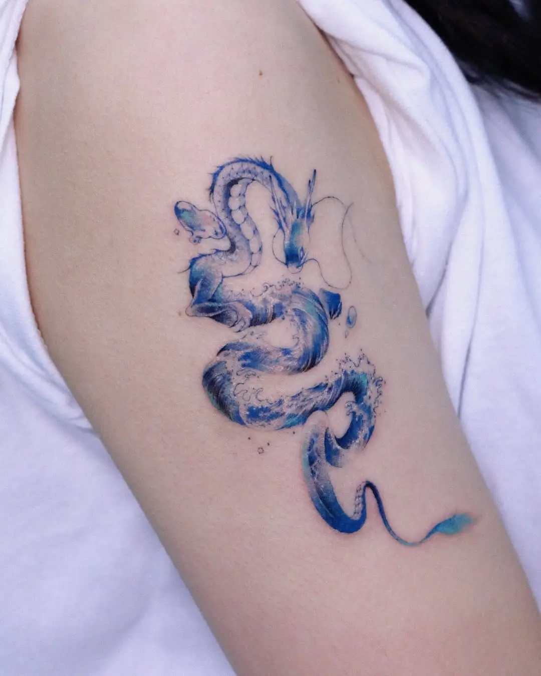 Breathtaking water dragon tattoo in vibrant blues