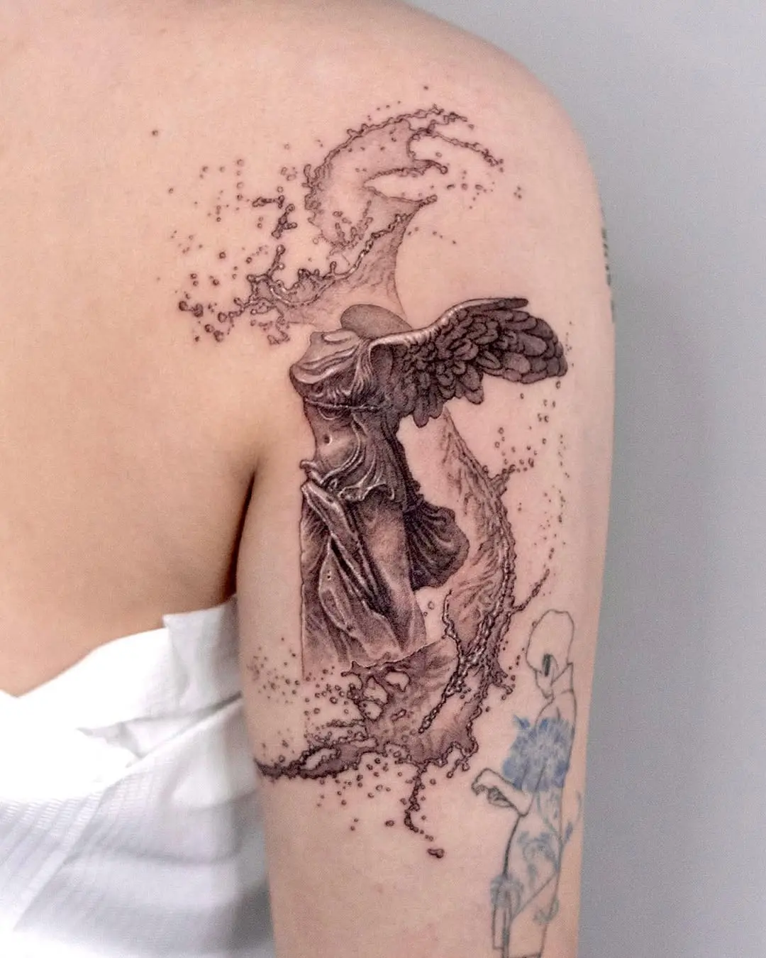 Elegant water-themed winged tattoo design
