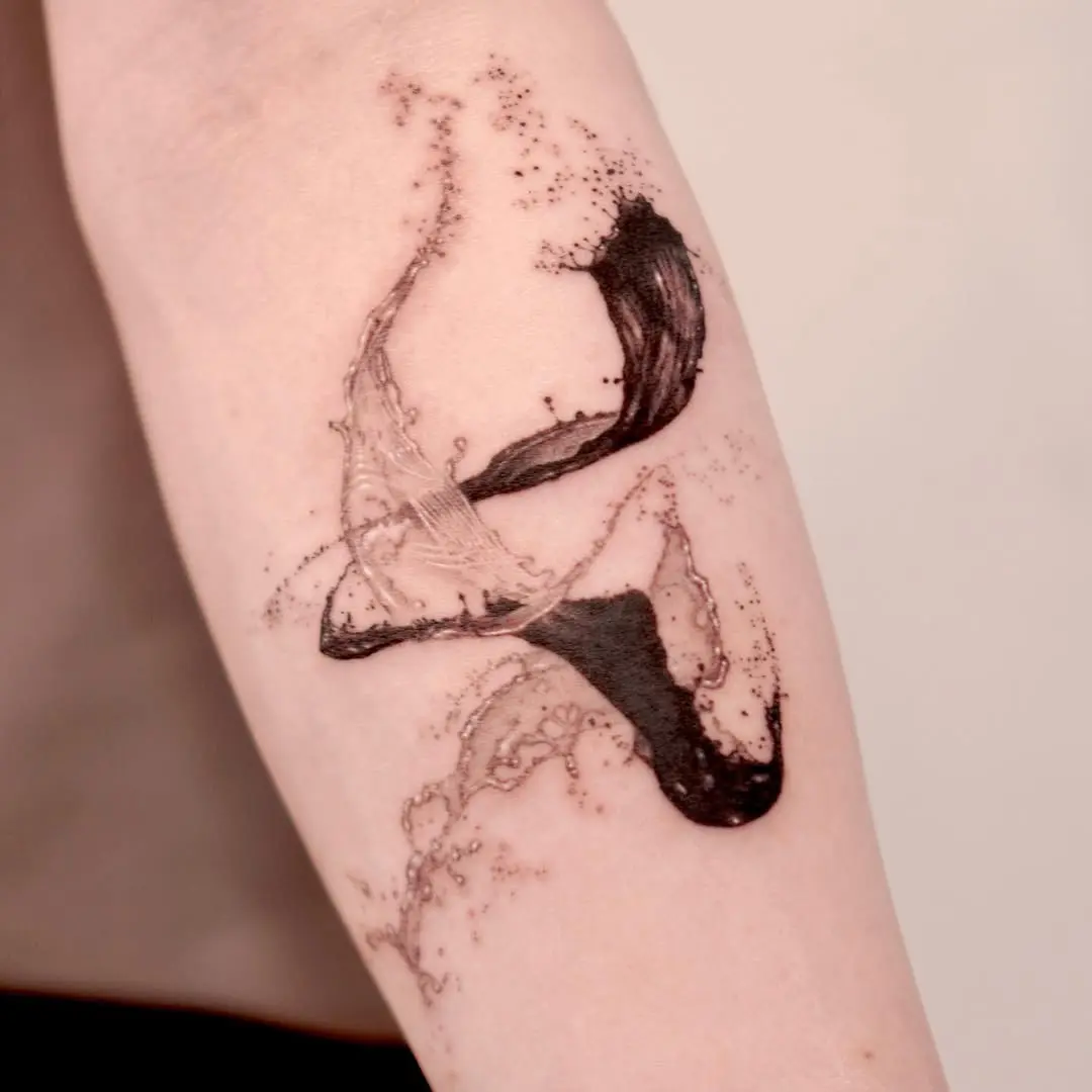 Dynamic water-inspired tattoo showcasing fluid movement