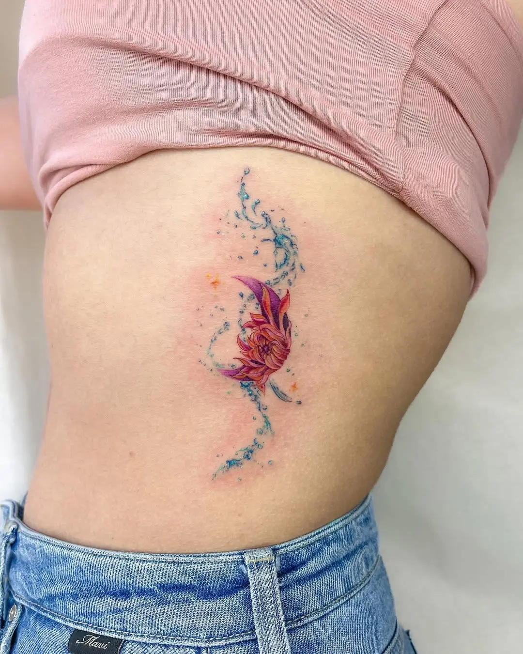 Vibrant aquatic-themed tattoo showcasing fluidity
