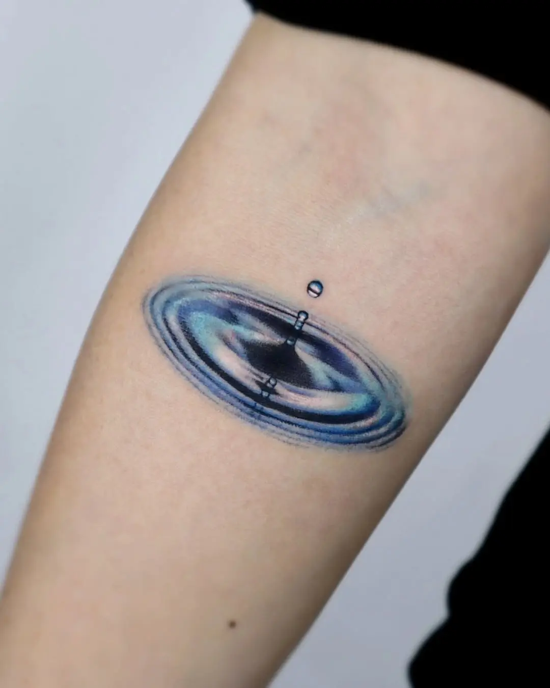 Captivating water ripple tattoo design on arm